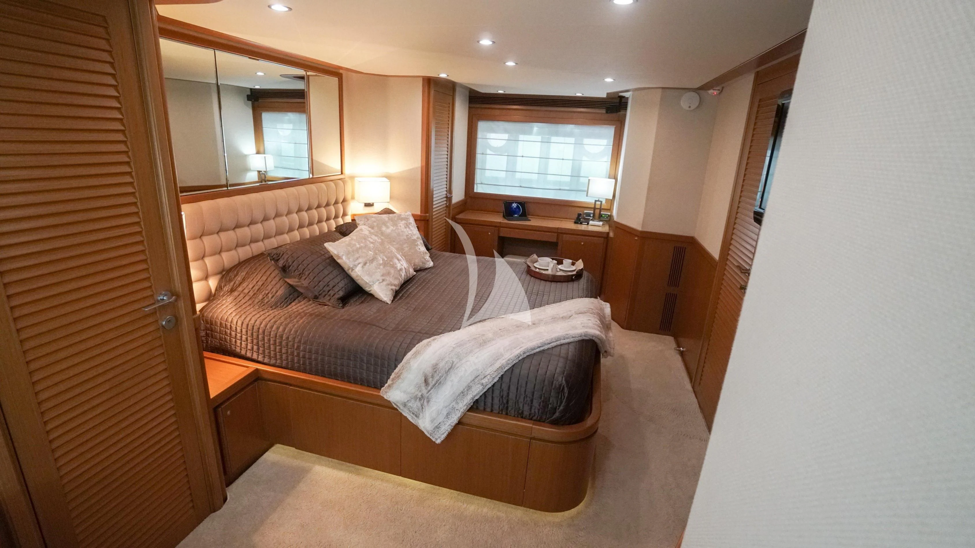a bedroom with a bed and a desk aboard NOMADA Yacht for Charter