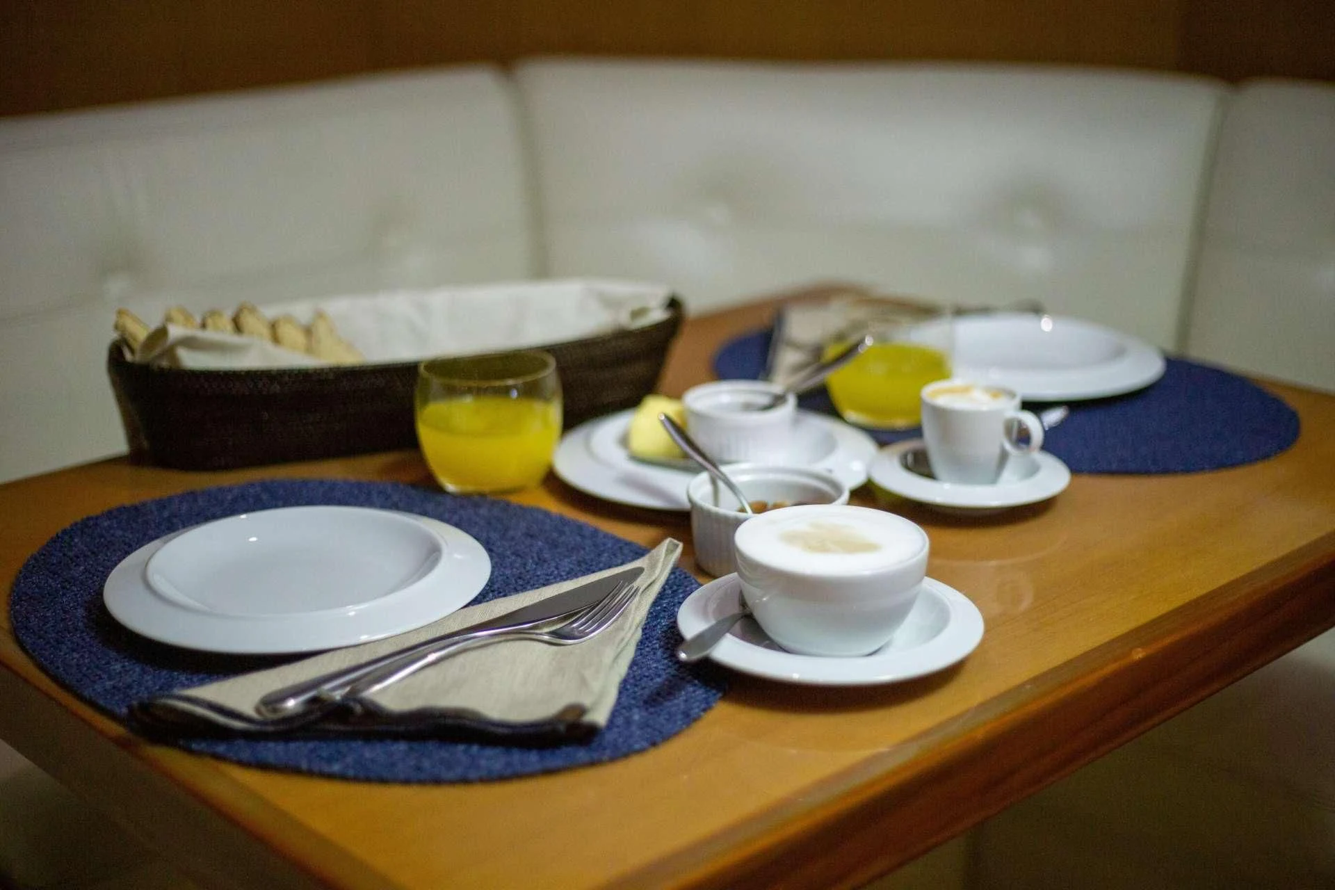 a table with plates and cups aboard NOMADA Yacht for Charter
