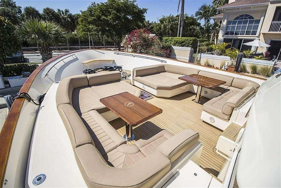 a deck with a table and chairs aboard NOMADA Yacht for Charter