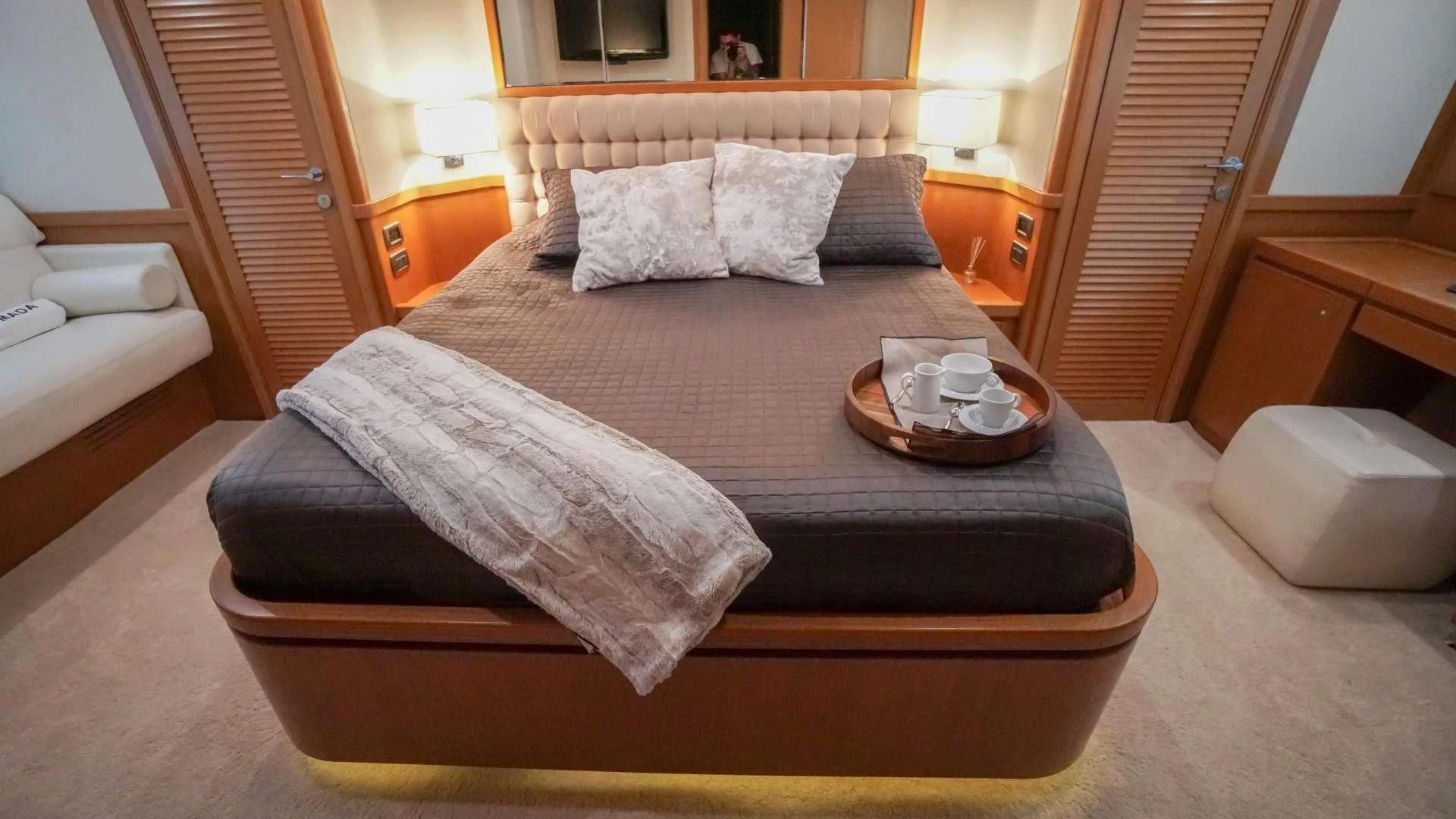 a bed with a tray of coffee aboard NOMADA Yacht for Charter