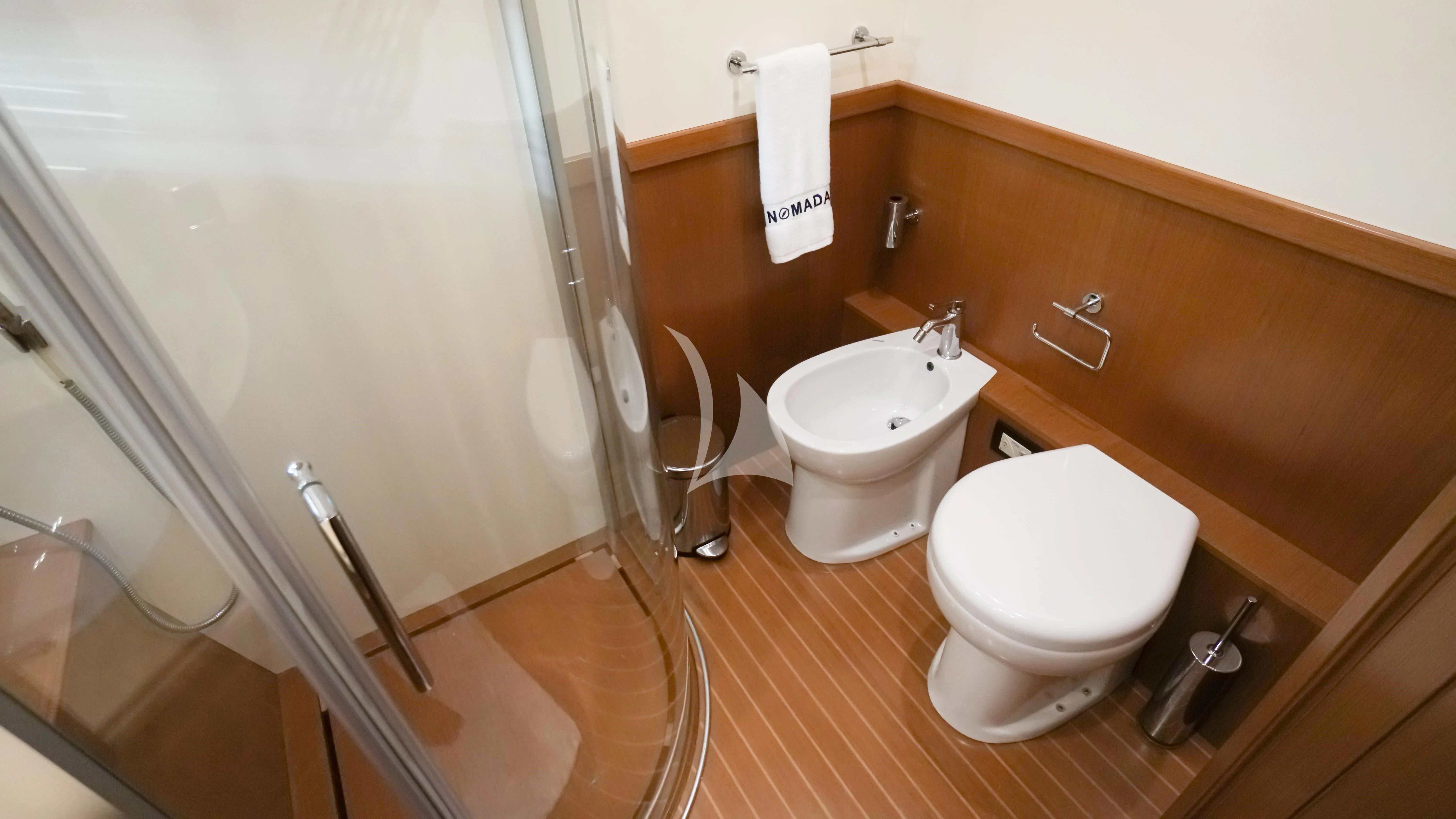a bathroom with a toilet and a sink aboard NOMADA Yacht for Charter