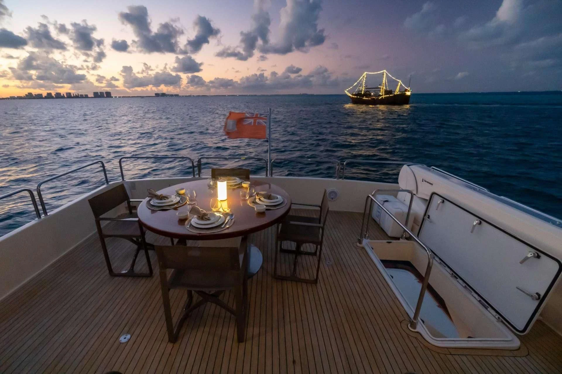 a table and chairs on a deck overlooking a large body of water aboard NOMADA Yacht for Charter