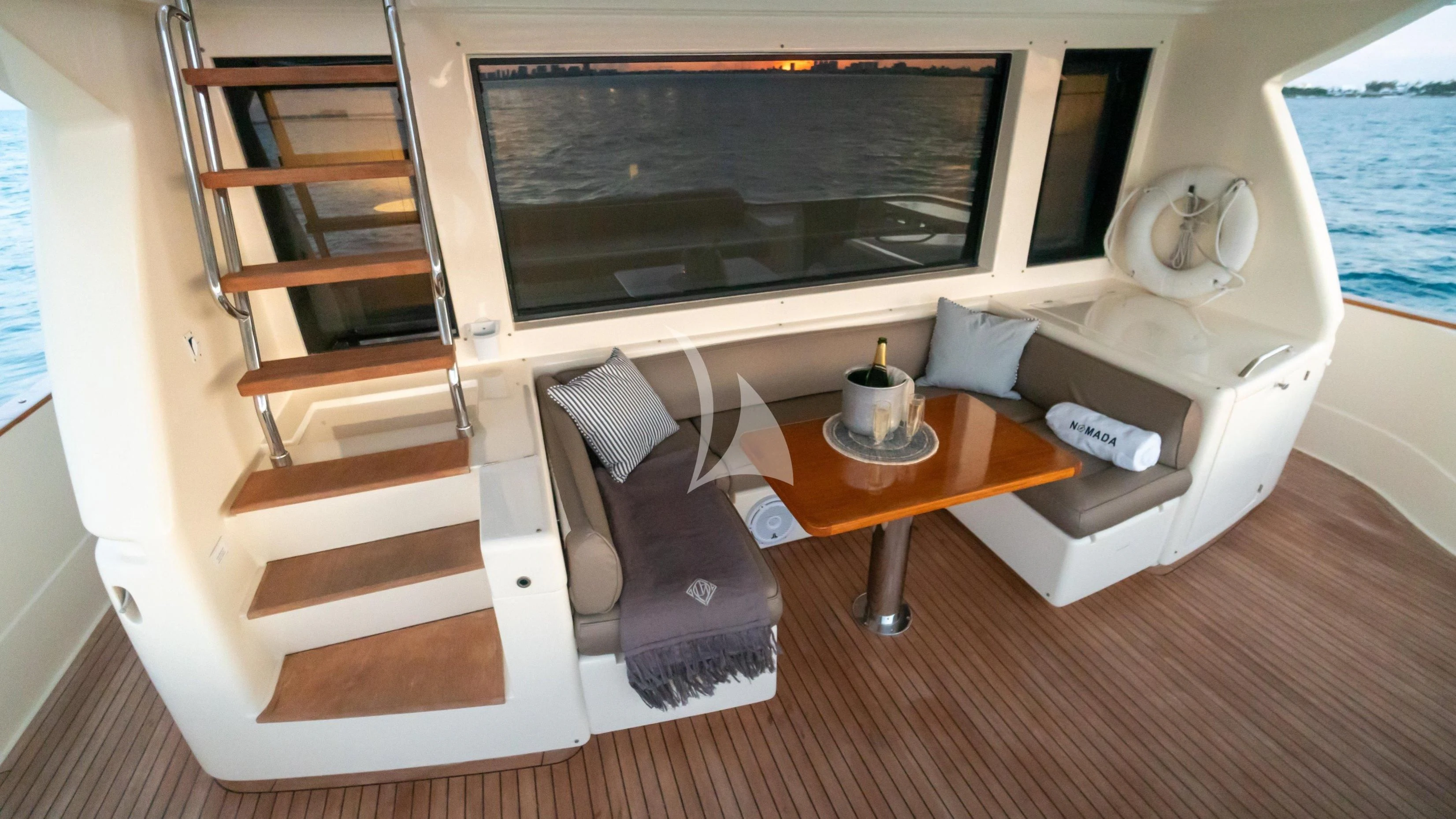 a room with a bed and a table aboard NOMADA Yacht for Charter