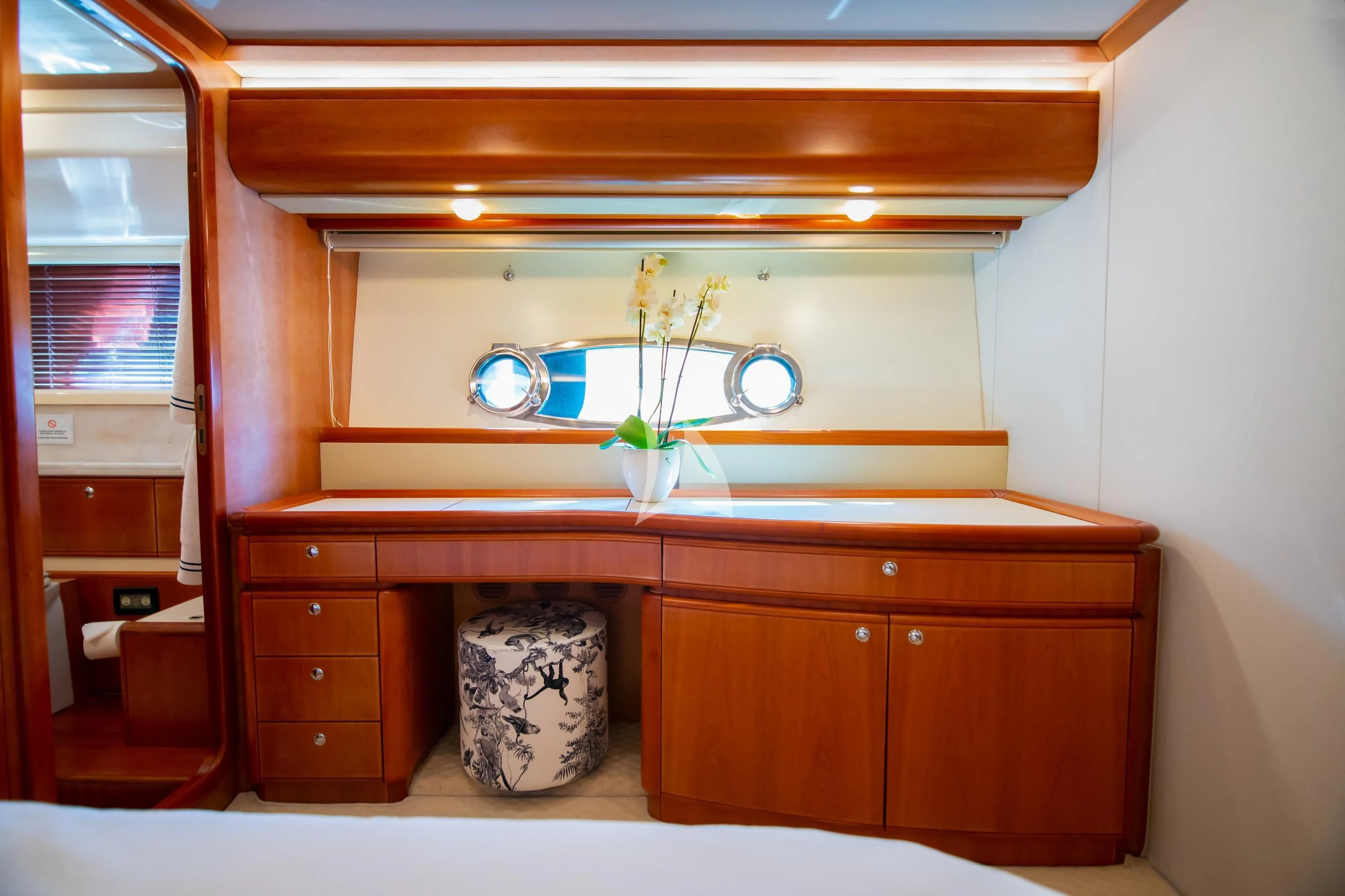 a wooden shelf with a vase with flowers on it aboard SOFIA D Yacht for Sale