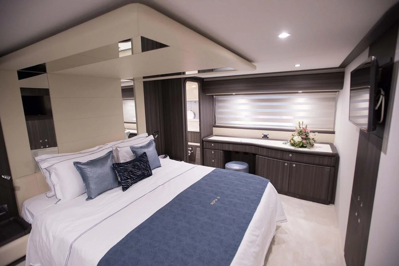 a bed with blue sheets aboard SOFIA D Yacht for Sale