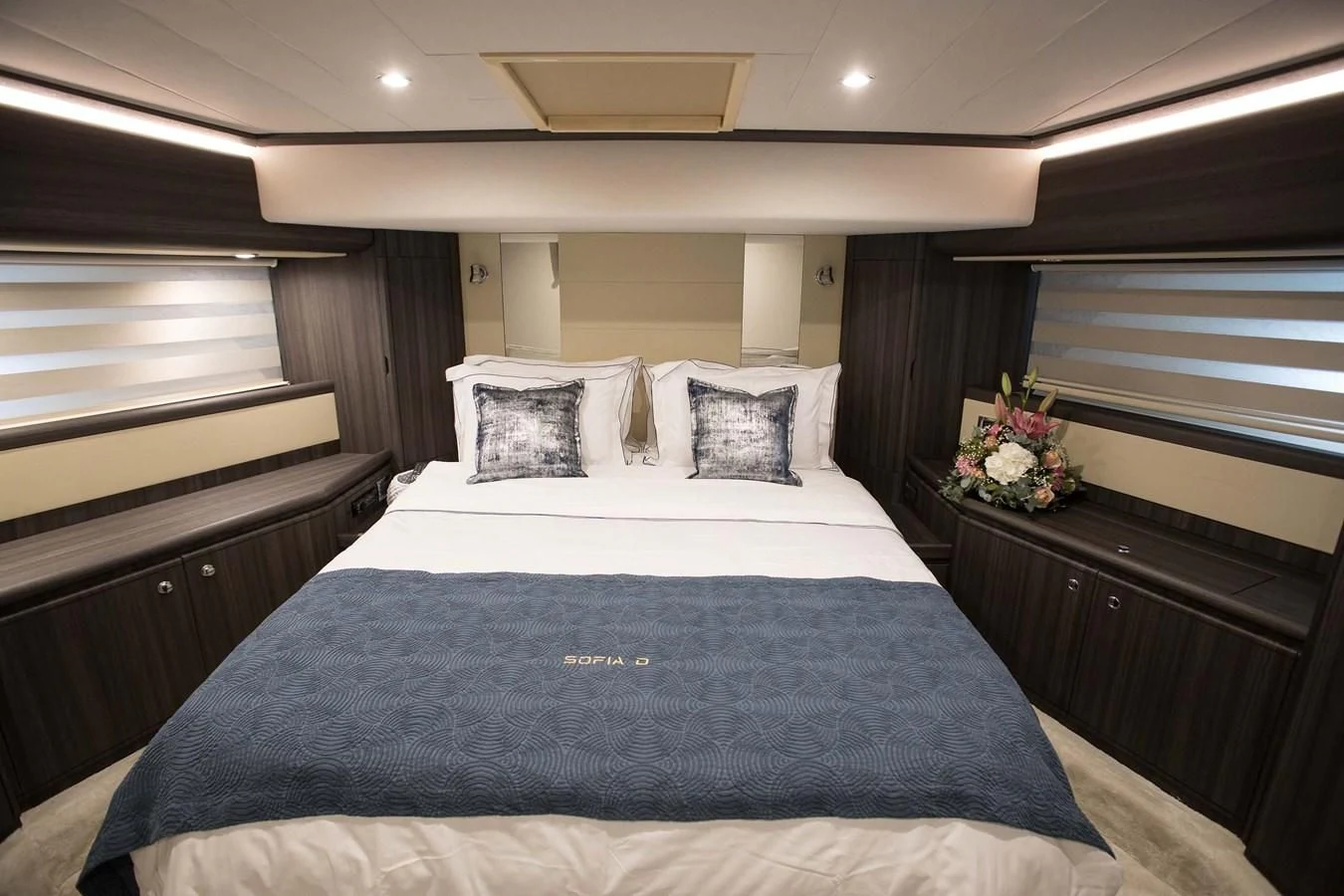 a bed with a blue blanket aboard SOFIA D Yacht for Sale