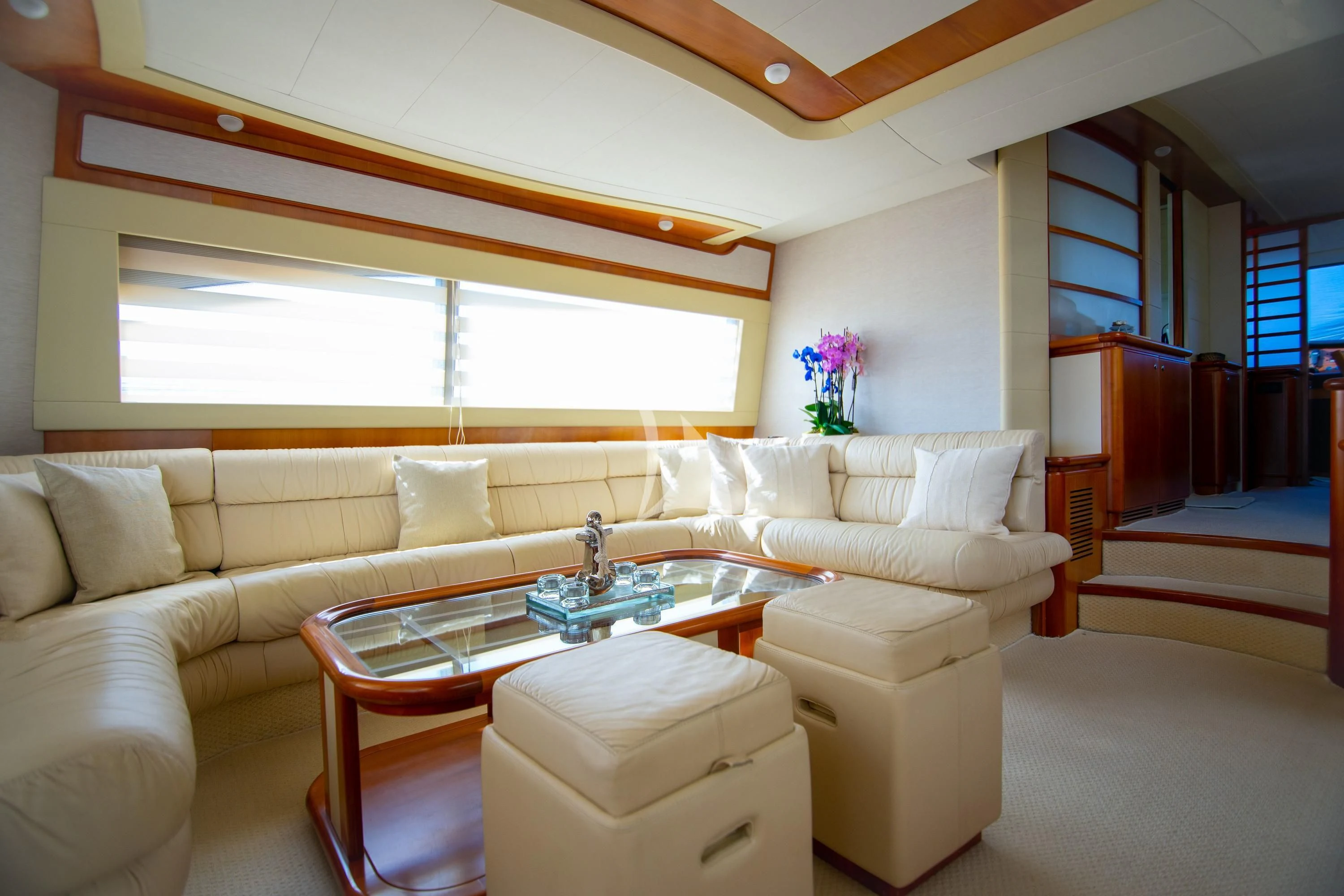 a living room with a table and couches aboard SOFIA D Yacht for Sale