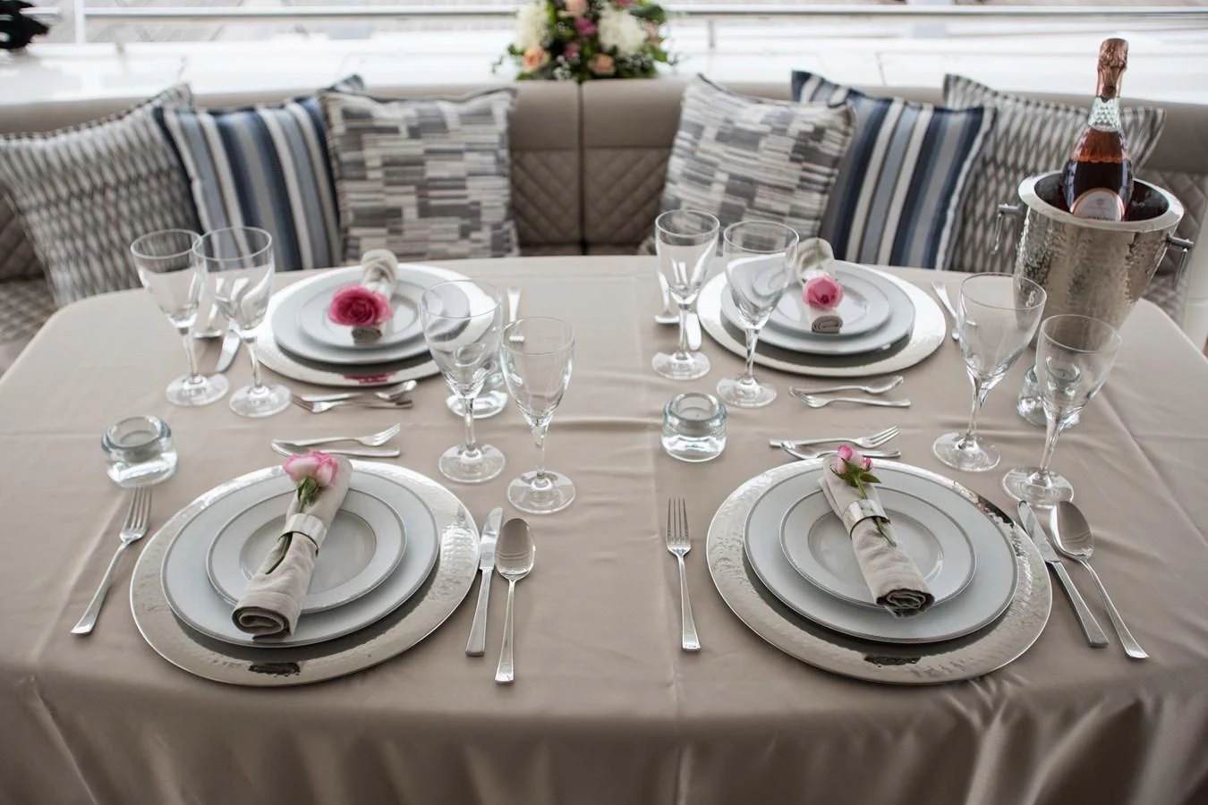 a table set with plates and glasses aboard SOFIA D Yacht for Sale