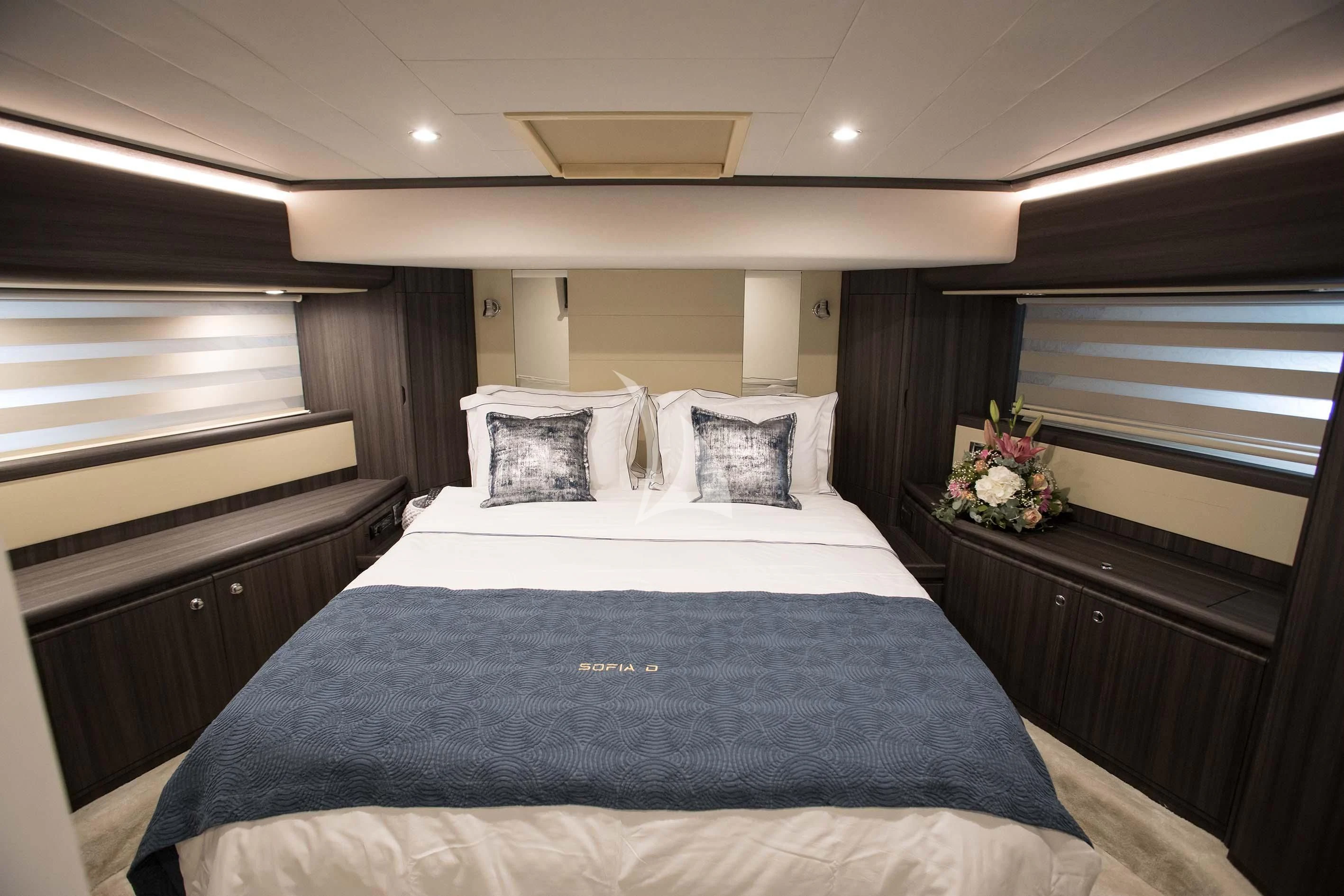 a bed with blue sheets aboard SOFIA D Yacht for Sale