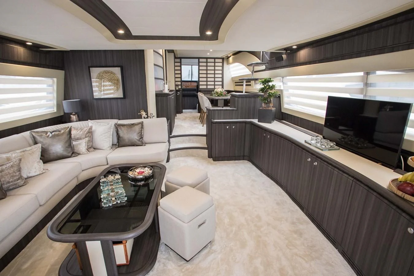 a living room with a large white sofa and a large tv aboard SOFIA D Yacht for Sale