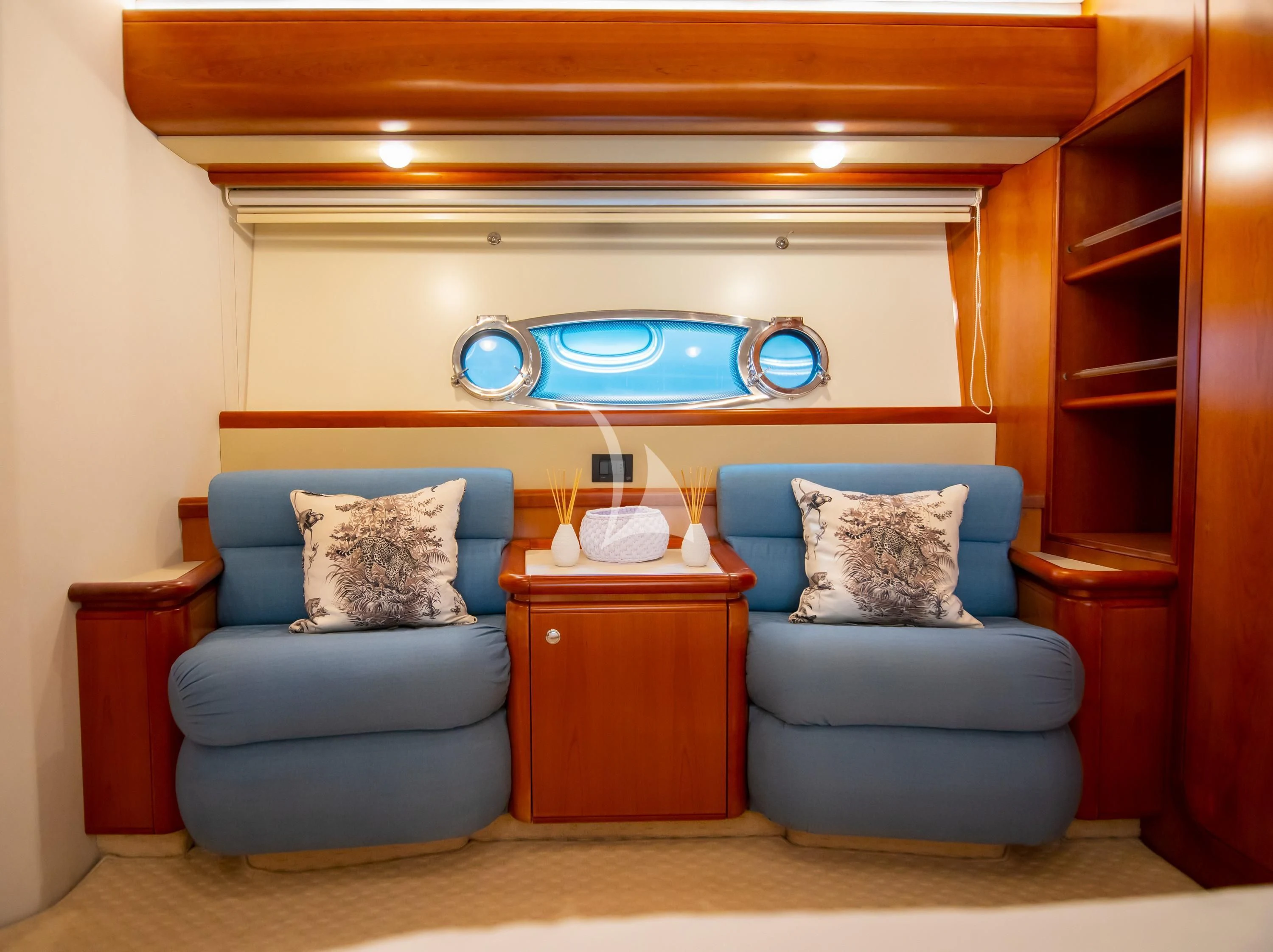a room with a blue couch and a blue chair aboard SOFIA D Yacht for Sale