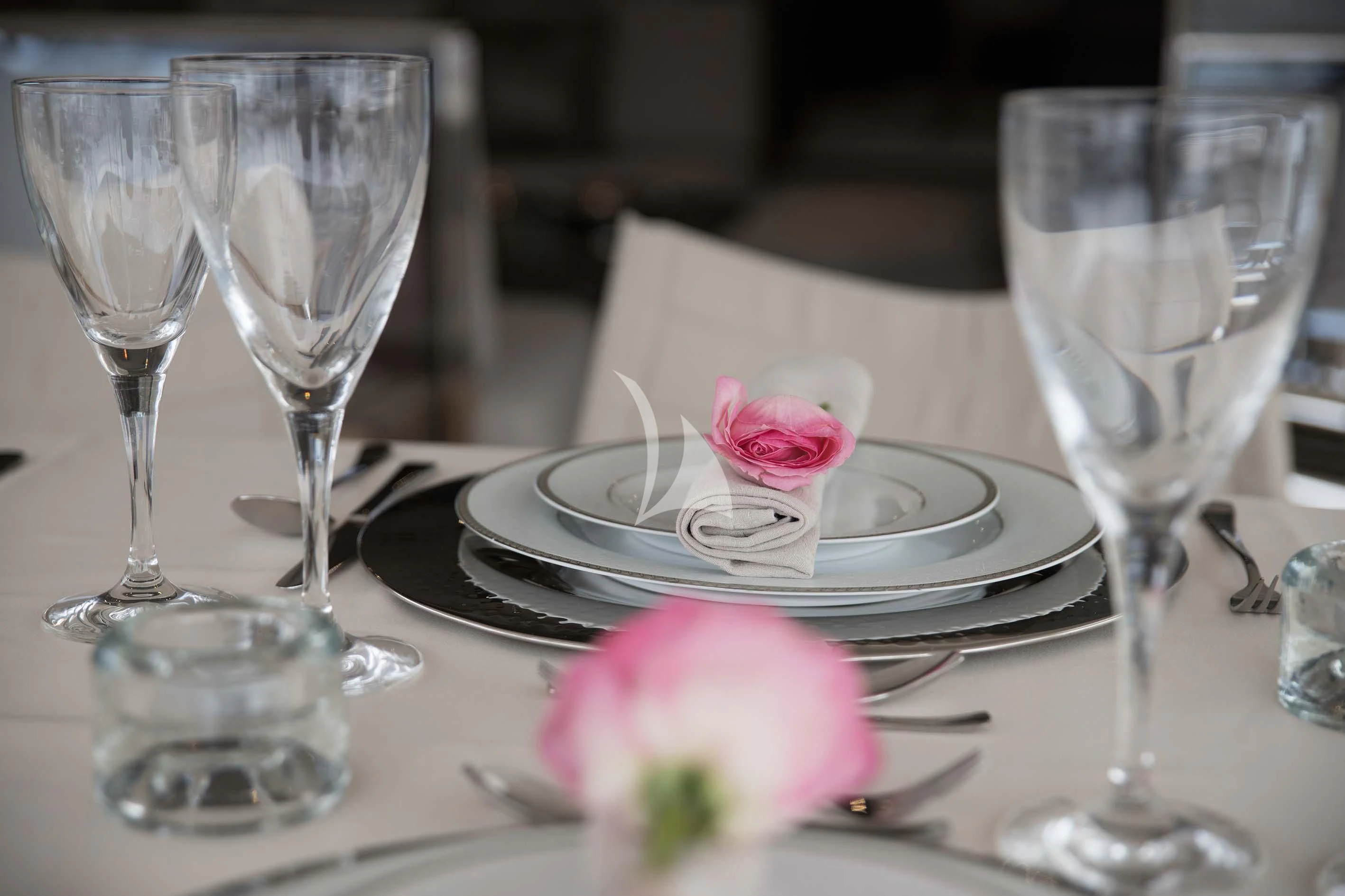 a table with wine glasses and plates aboard SOFIA D Yacht for Sale