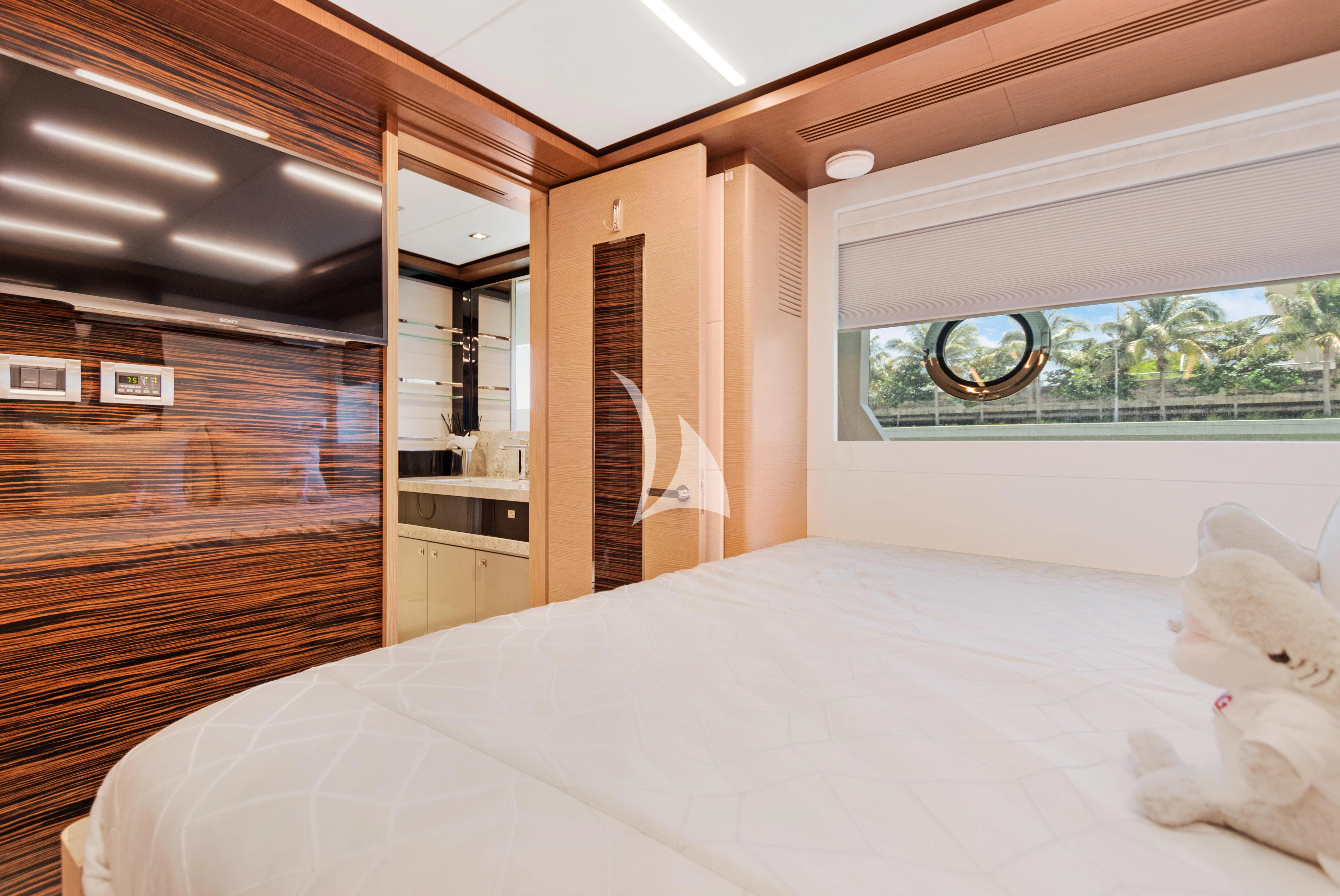 a bedroom with a large bed aboard MAKE BIG HAPPEN Yacht for Sale