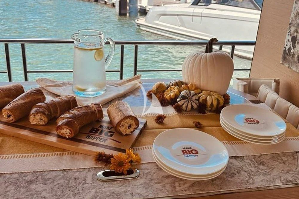 a table with food and drinks on it aboard MAKE BIG HAPPEN Yacht for Sale