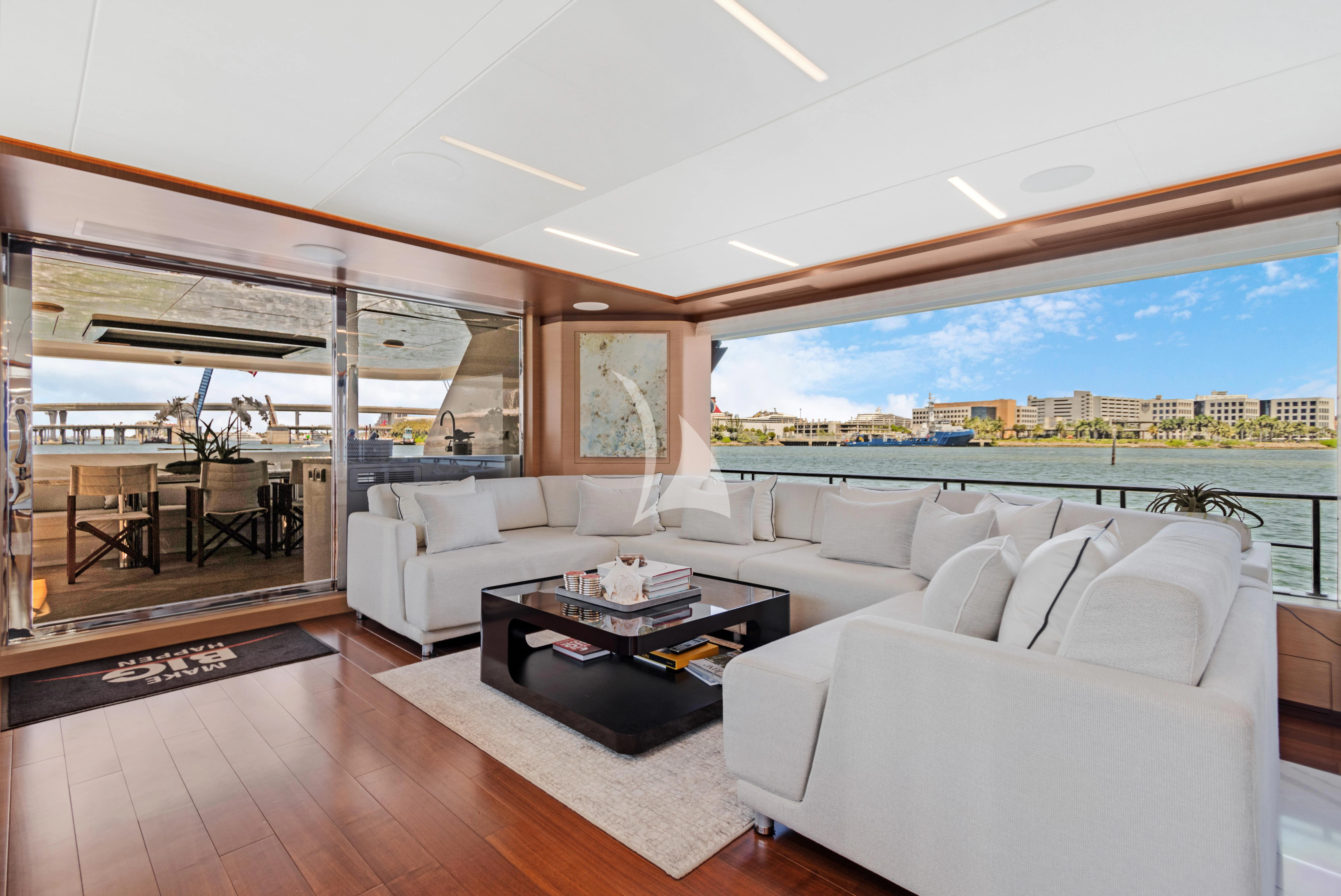 a living room with a large window aboard MAKE BIG HAPPEN Yacht for Sale