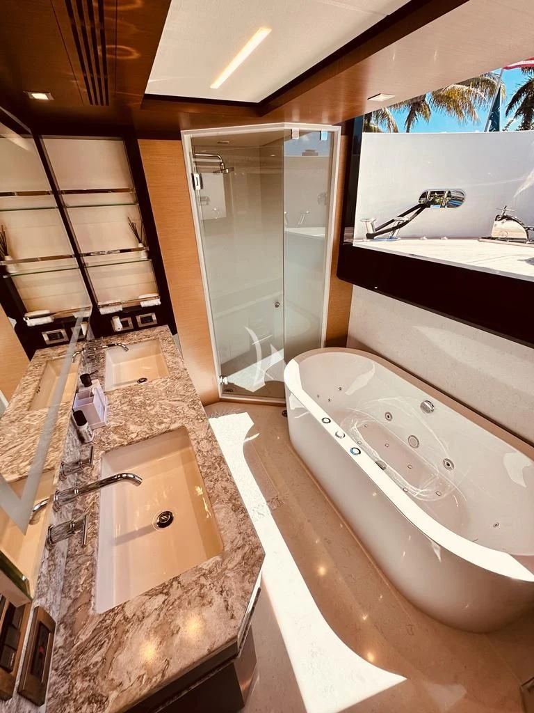 a bathroom with a bathtub and sink aboard MAKE BIG HAPPEN Yacht for Sale