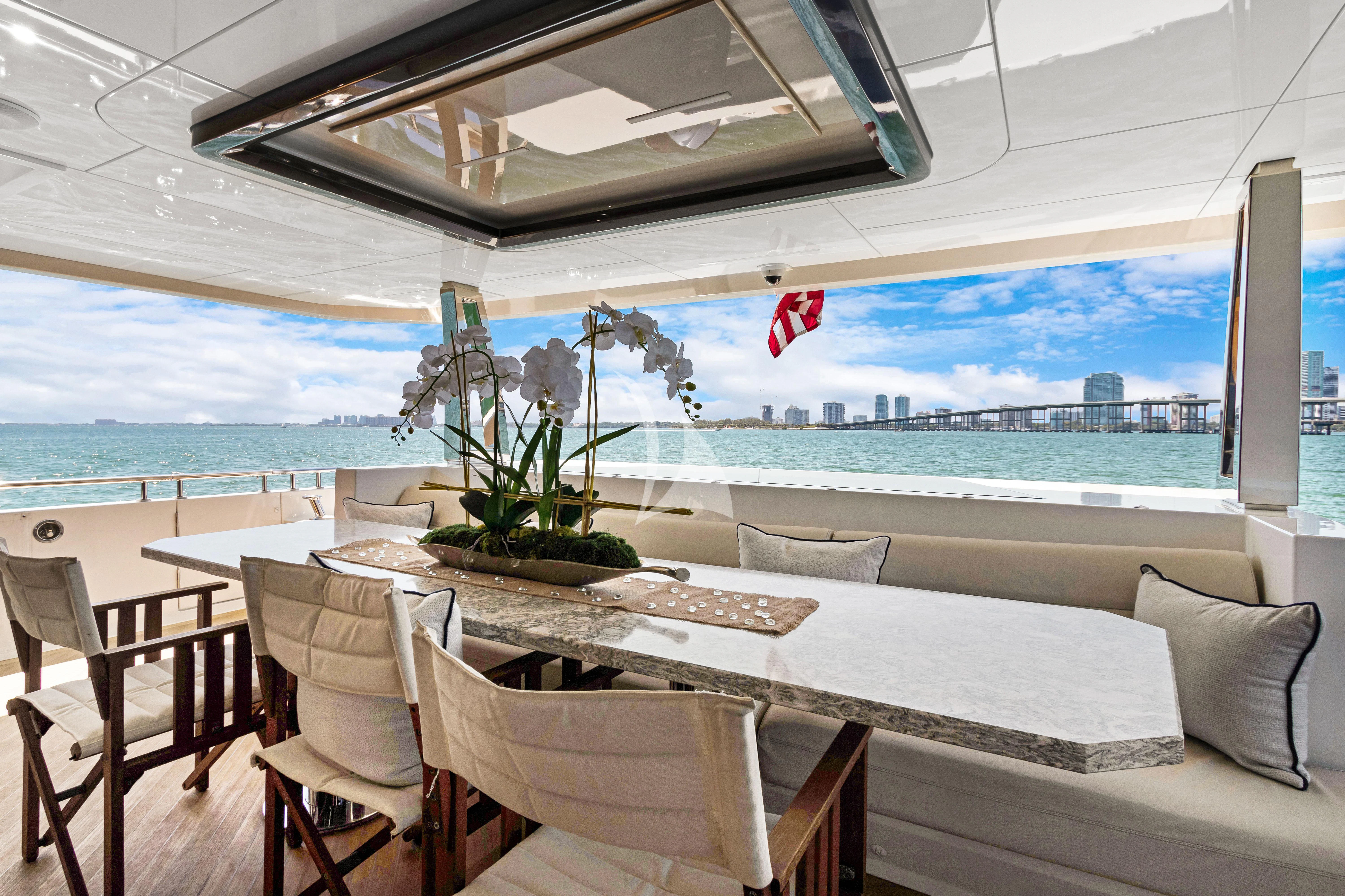 a room with a table and chairs aboard MAKE BIG HAPPEN Yacht for Sale