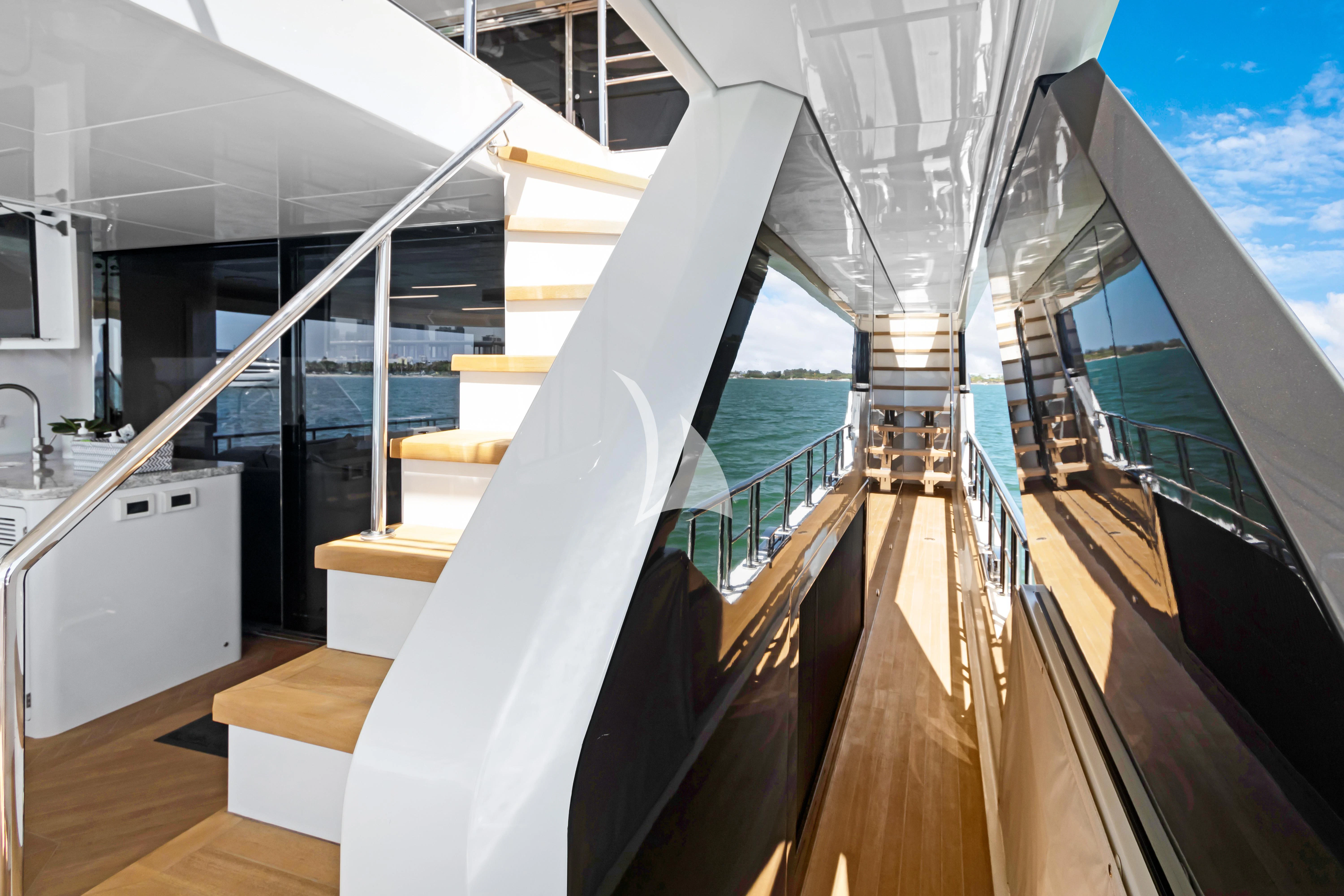 a staircase with glass walls aboard MAKE BIG HAPPEN Yacht for Sale