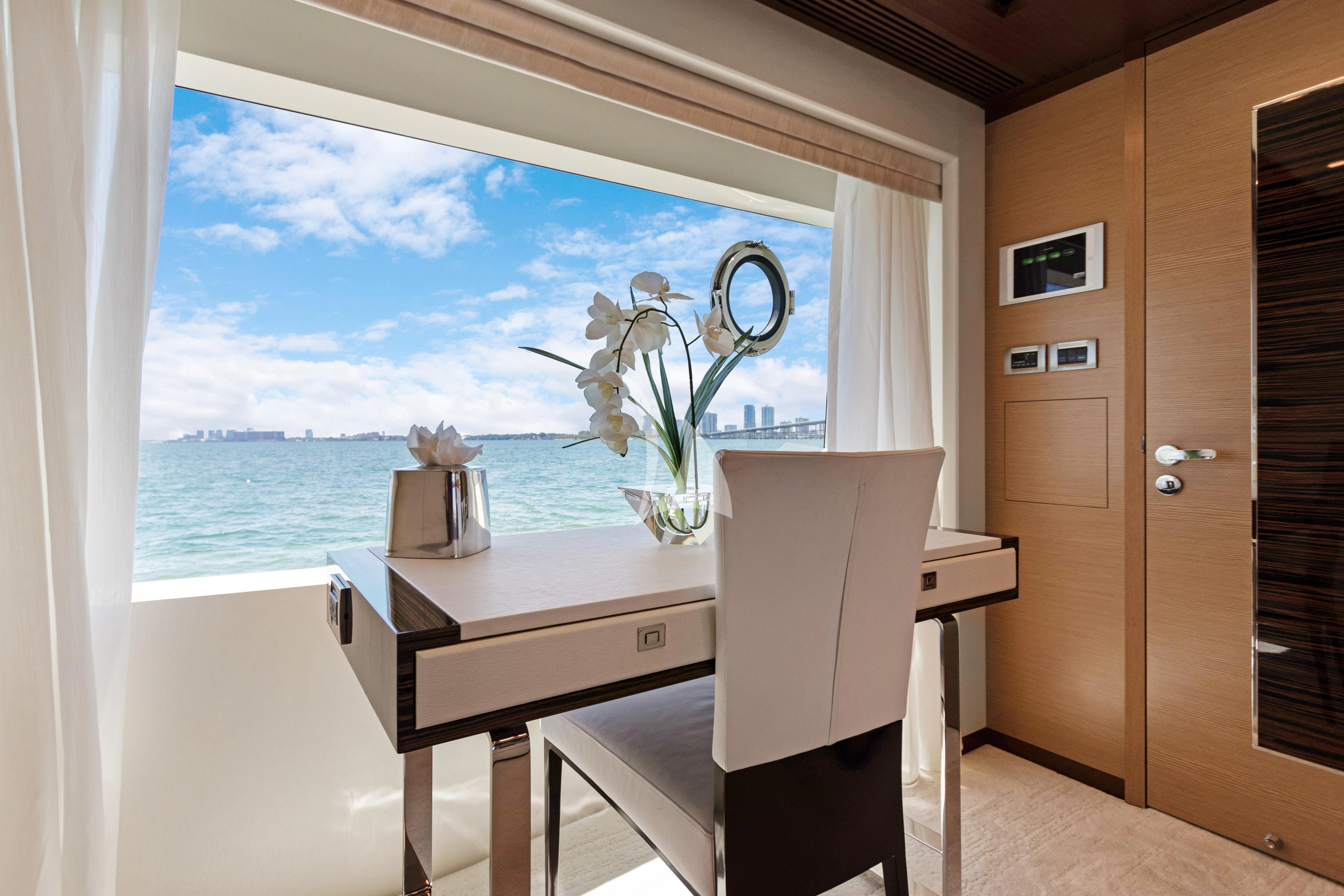 a room with a desk and a window aboard MAKE BIG HAPPEN Yacht for Sale