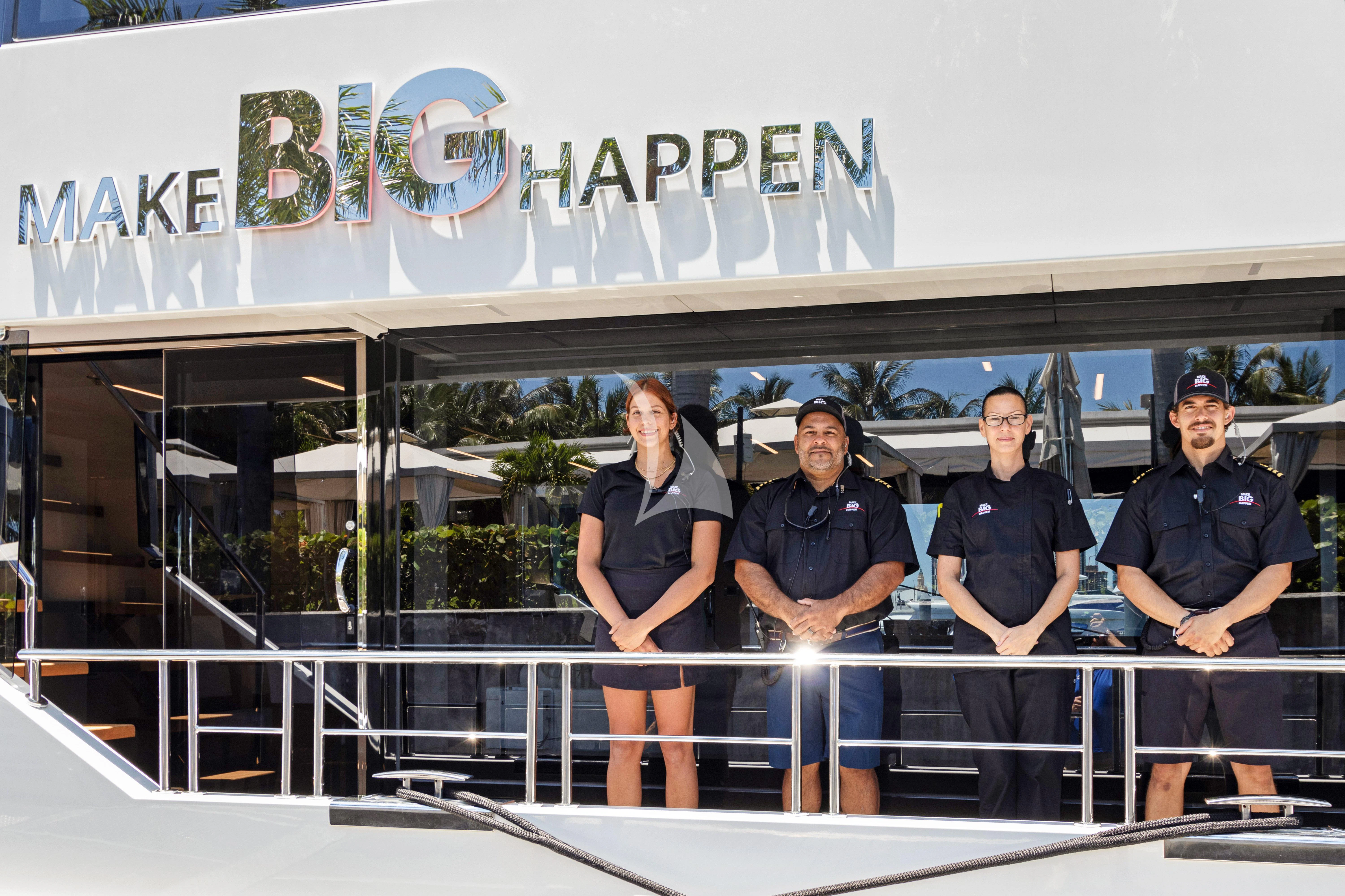 a group of men posing for a photo aboard MAKE BIG HAPPEN Yacht for Sale