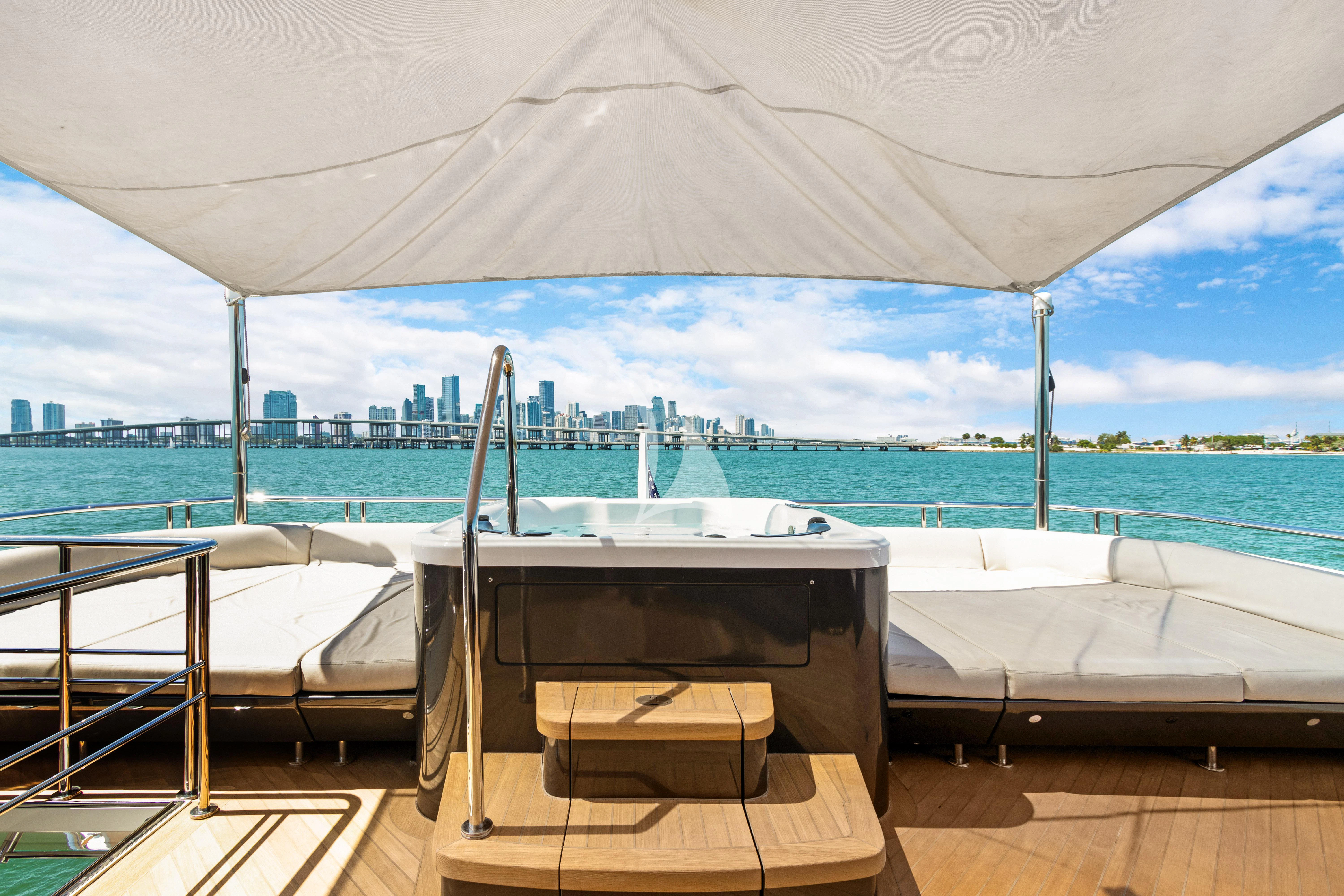 a lounge chair on a deck overlooking a body of water aboard MAKE BIG HAPPEN Yacht for Sale