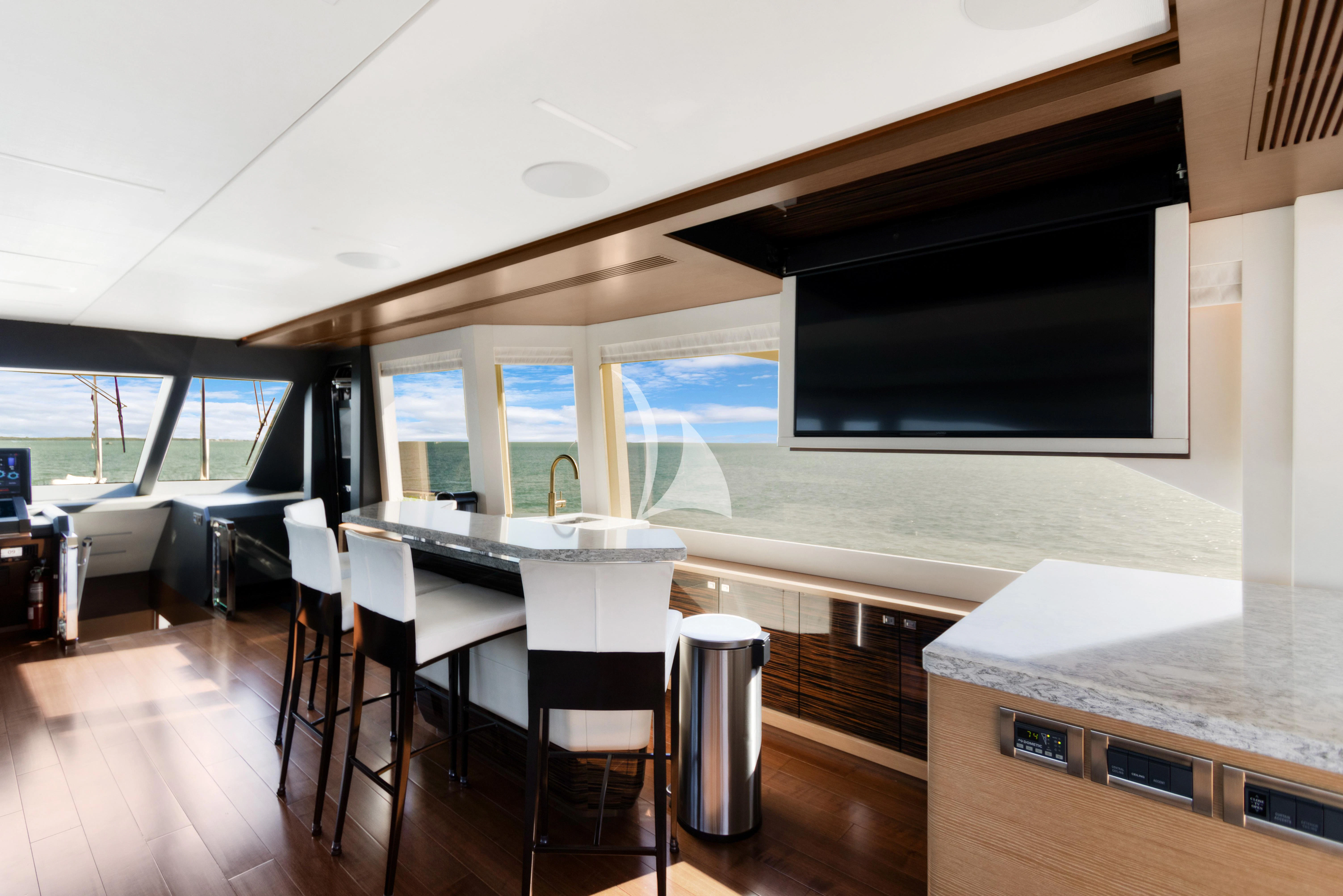 a room with a table and chairs aboard MAKE BIG HAPPEN Yacht for Sale