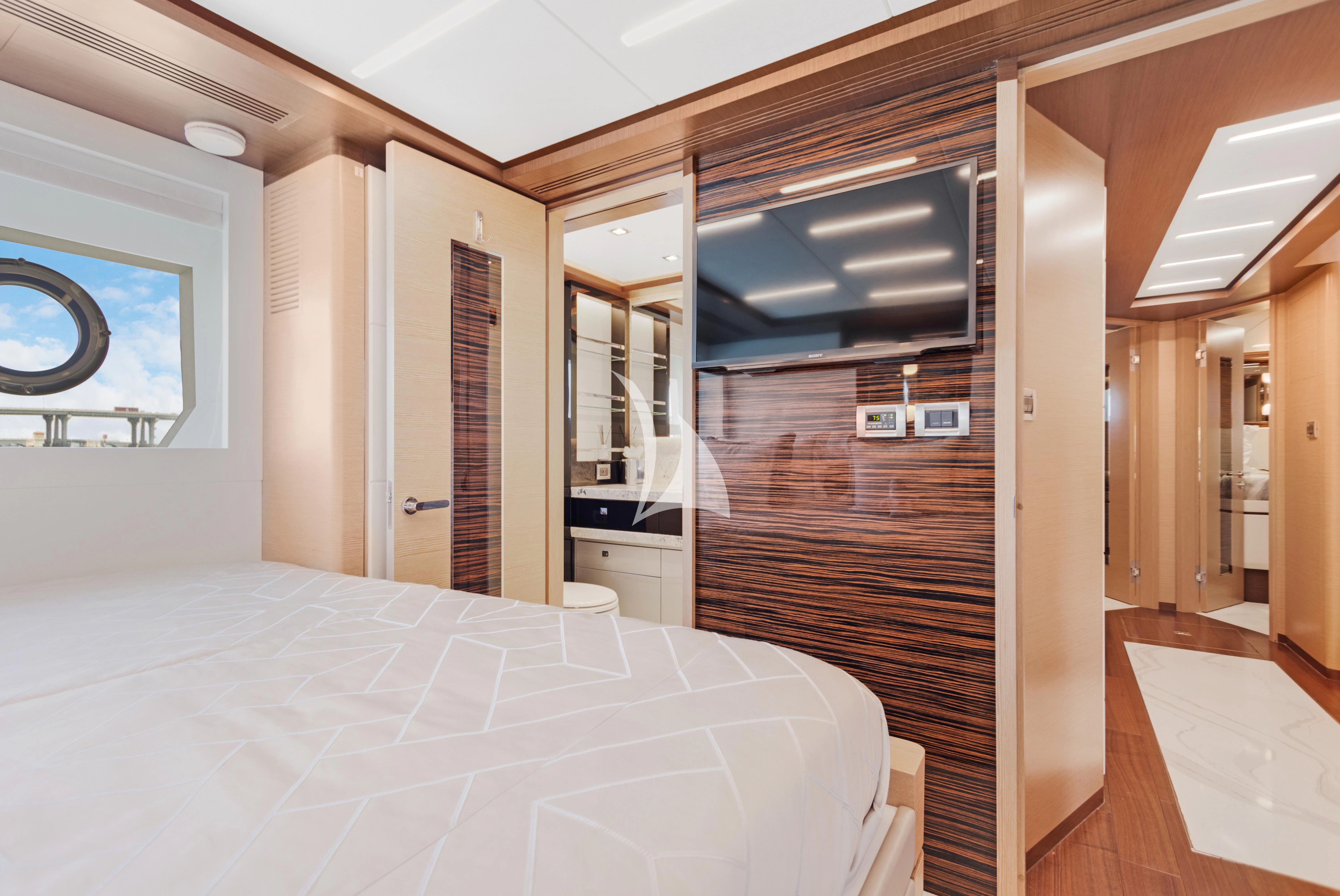 a room with a bed and a door aboard MAKE BIG HAPPEN Yacht for Sale