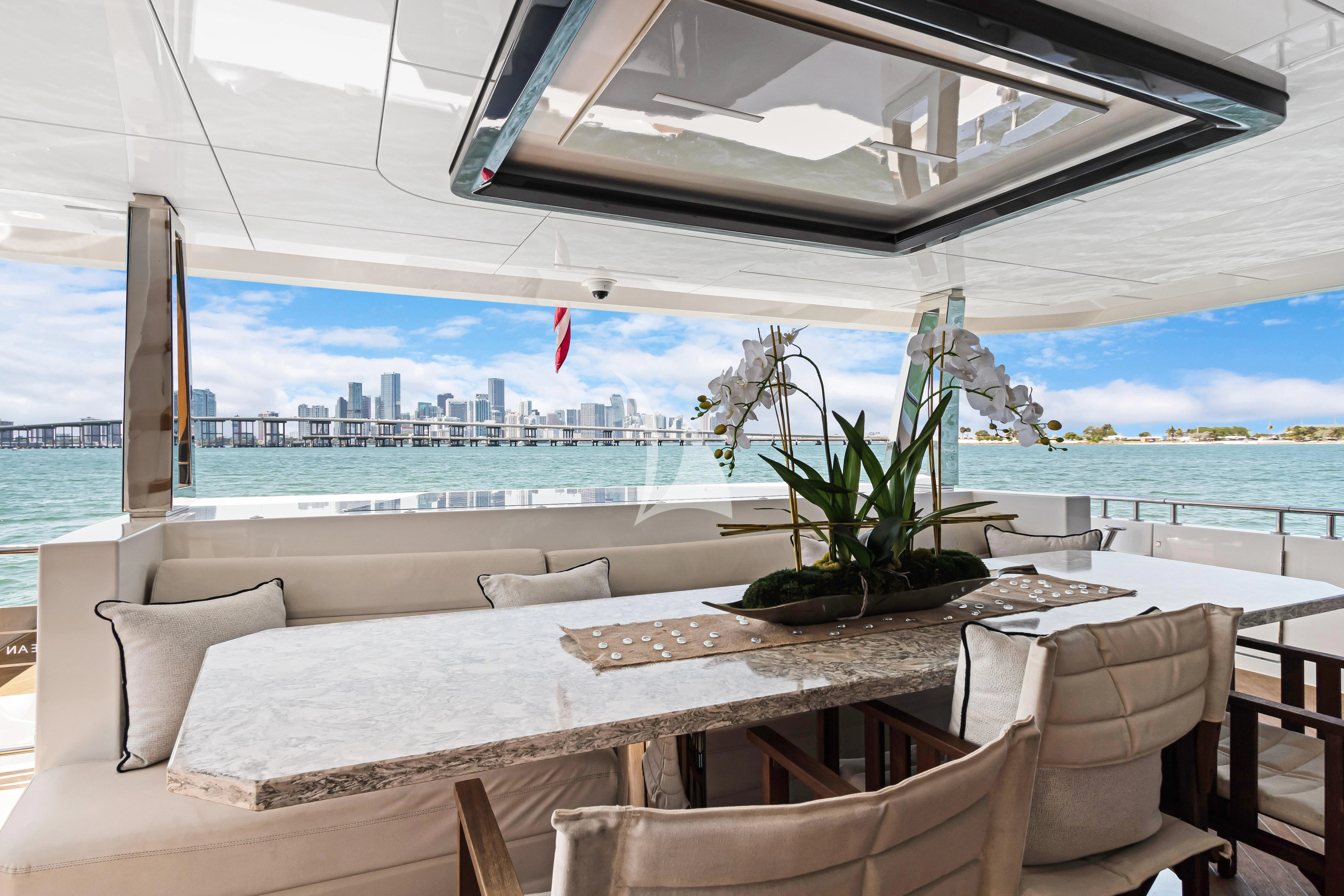 a room with a table and chairs aboard MAKE BIG HAPPEN Yacht for Sale