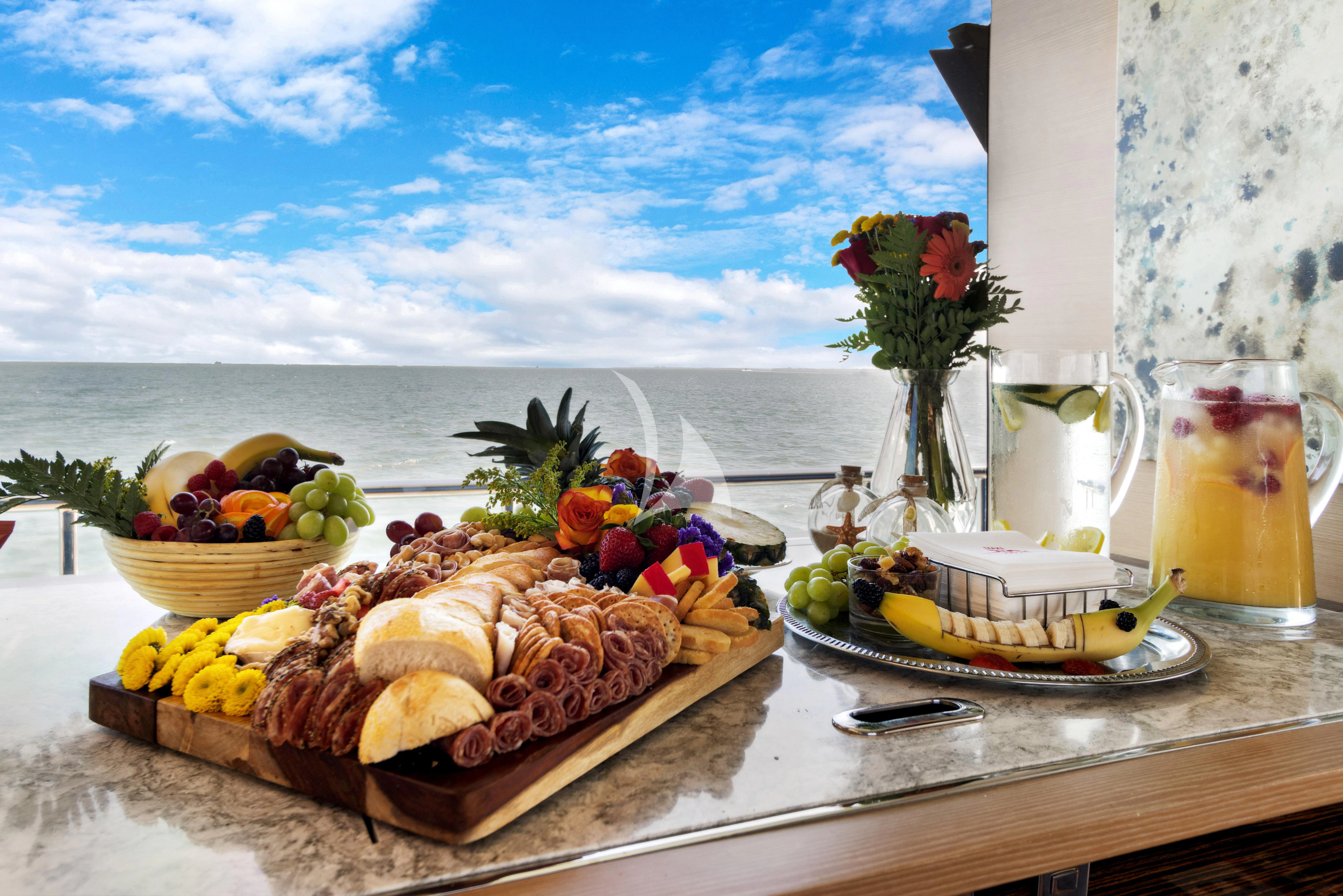 a table with food and drinks on it aboard MAKE BIG HAPPEN Yacht for Sale