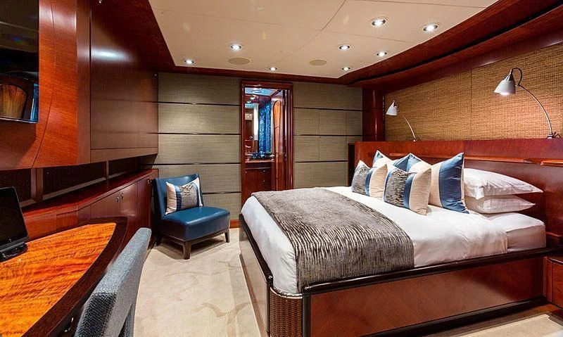 a room with a bed and a chair aboard USHER Yacht for Sale