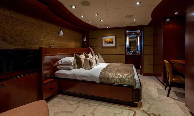 a room with a bed and a chair aboard USHER Yacht for Sale