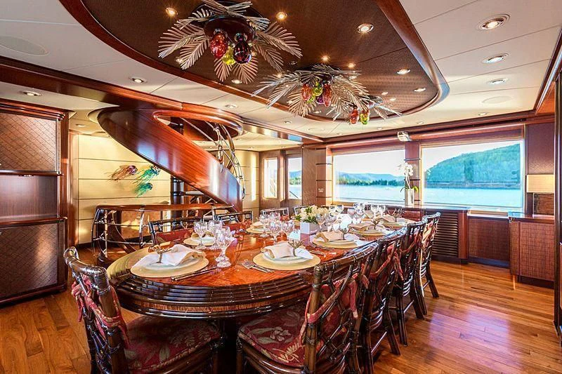 a dining room with a table set for a dinner party aboard USHER Yacht for Sale