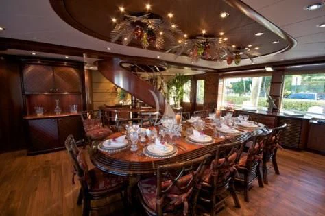 a dining room with a table and chairs aboard USHER Yacht for Sale