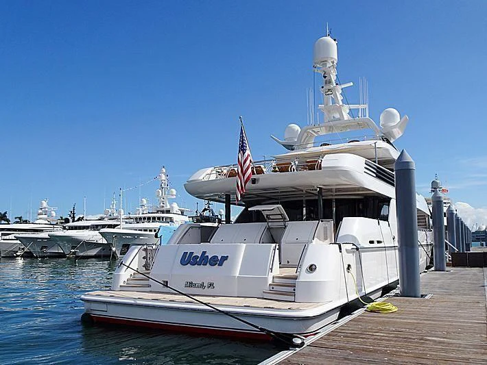 a large white boat docked at a dock aboard USHER Yacht for Sale