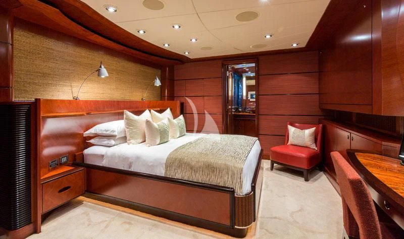 a room with a bed and a chair aboard USHER Yacht for Sale