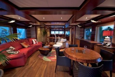 a living room with a red couch aboard USHER Yacht for Sale