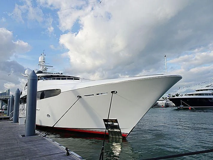 a large white yacht docked at a pier aboard USHER Yacht for Sale