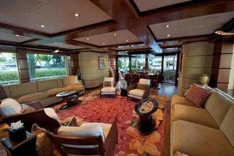 a living room with a large red rug and a large window aboard USHER Yacht for Sale