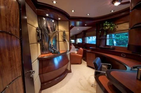 a room with a tv and a table aboard USHER Yacht for Sale