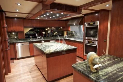 a kitchen with wooden cabinets aboard USHER Yacht for Sale