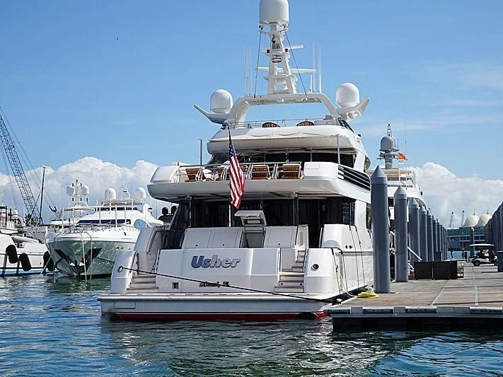 a large white boat docked at a dock aboard USHER Yacht for Sale