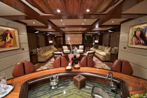 a large living room with a large table and chairs aboard USHER Yacht for Sale