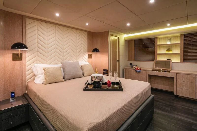 a large bedroom with a bed aboard SAINT Yacht for Sale