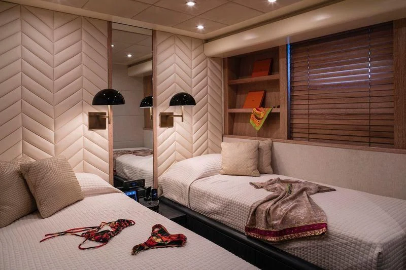 a bedroom with a bed and a lamp aboard SAINT Yacht for Sale