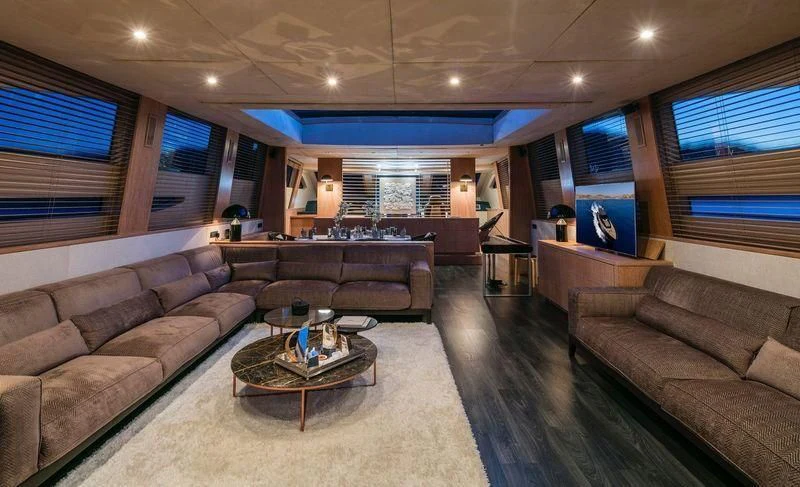a living room with a leather couch aboard SAINT Yacht for Sale