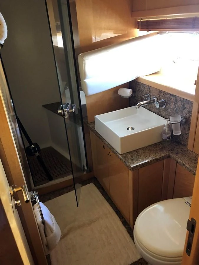 a bathroom with a sink and toilet aboard UNICO Yacht for Sale