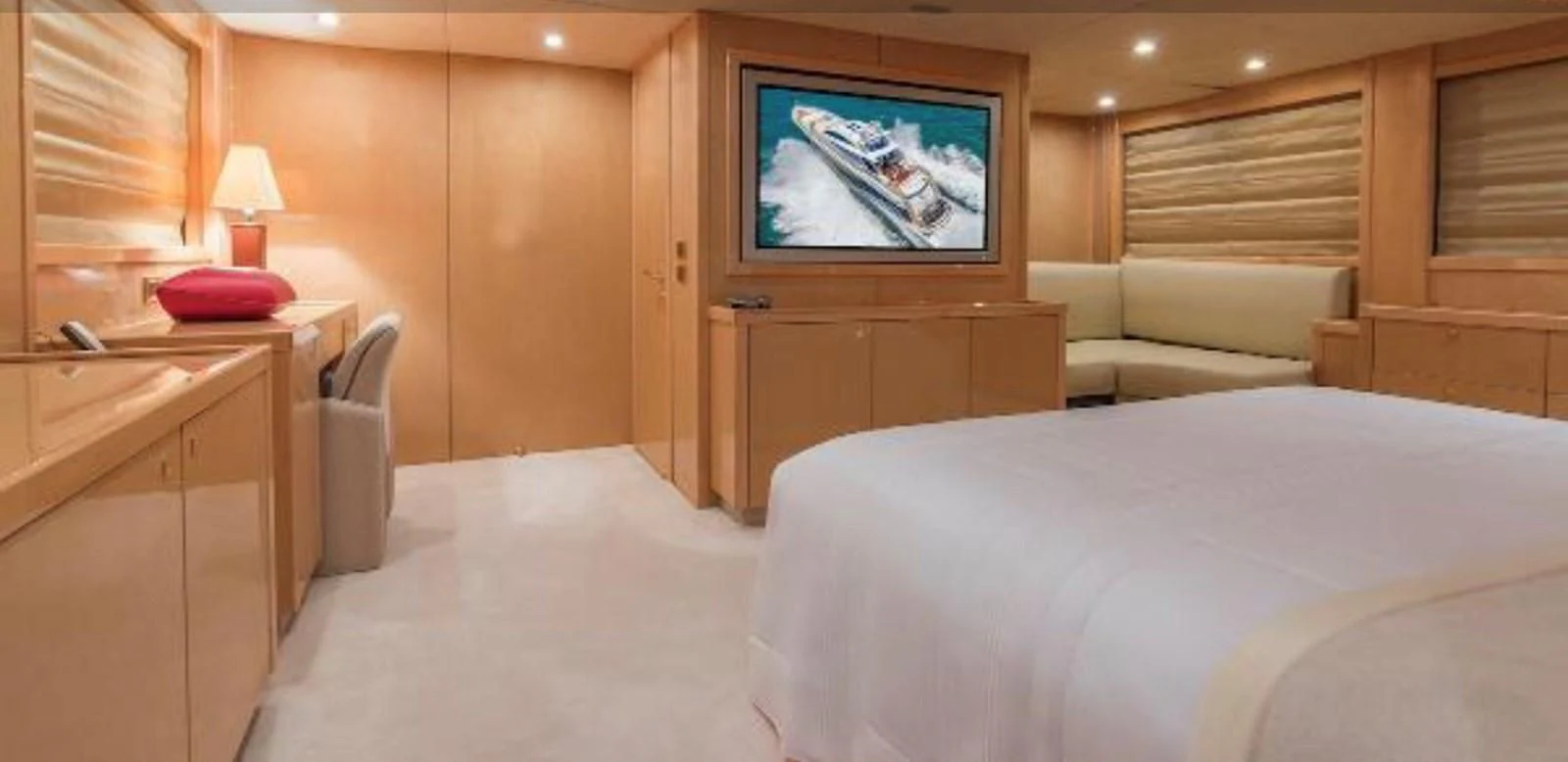 a bedroom with a bed and a television aboard UNICO Yacht for Sale