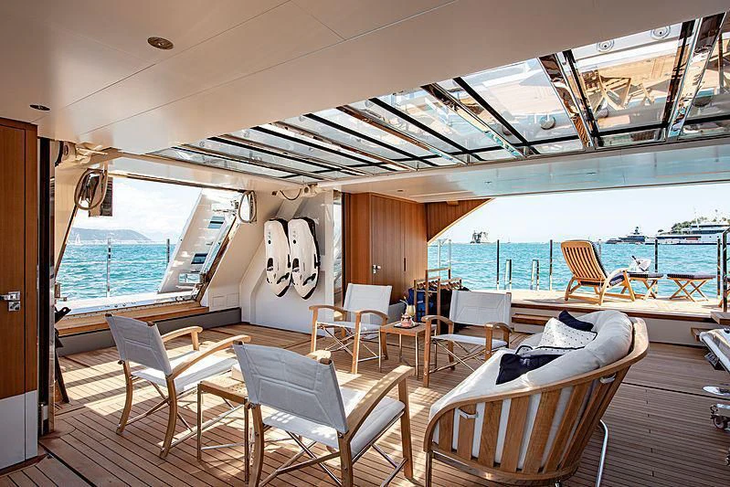 a boat with chairs and tables aboard LADY LENA Yacht for Sale
