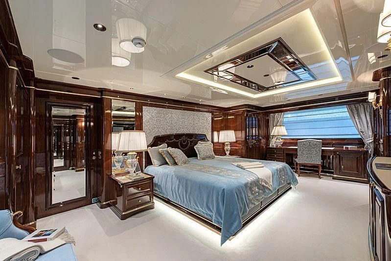 a large bedroom with a large bed aboard LADY LENA Yacht for Sale