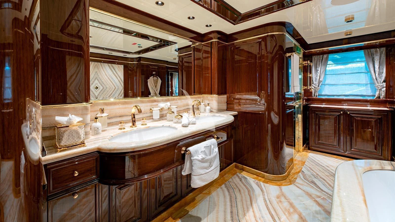 a bathroom with a sink and a mirror aboard LADY LENA Yacht for Sale